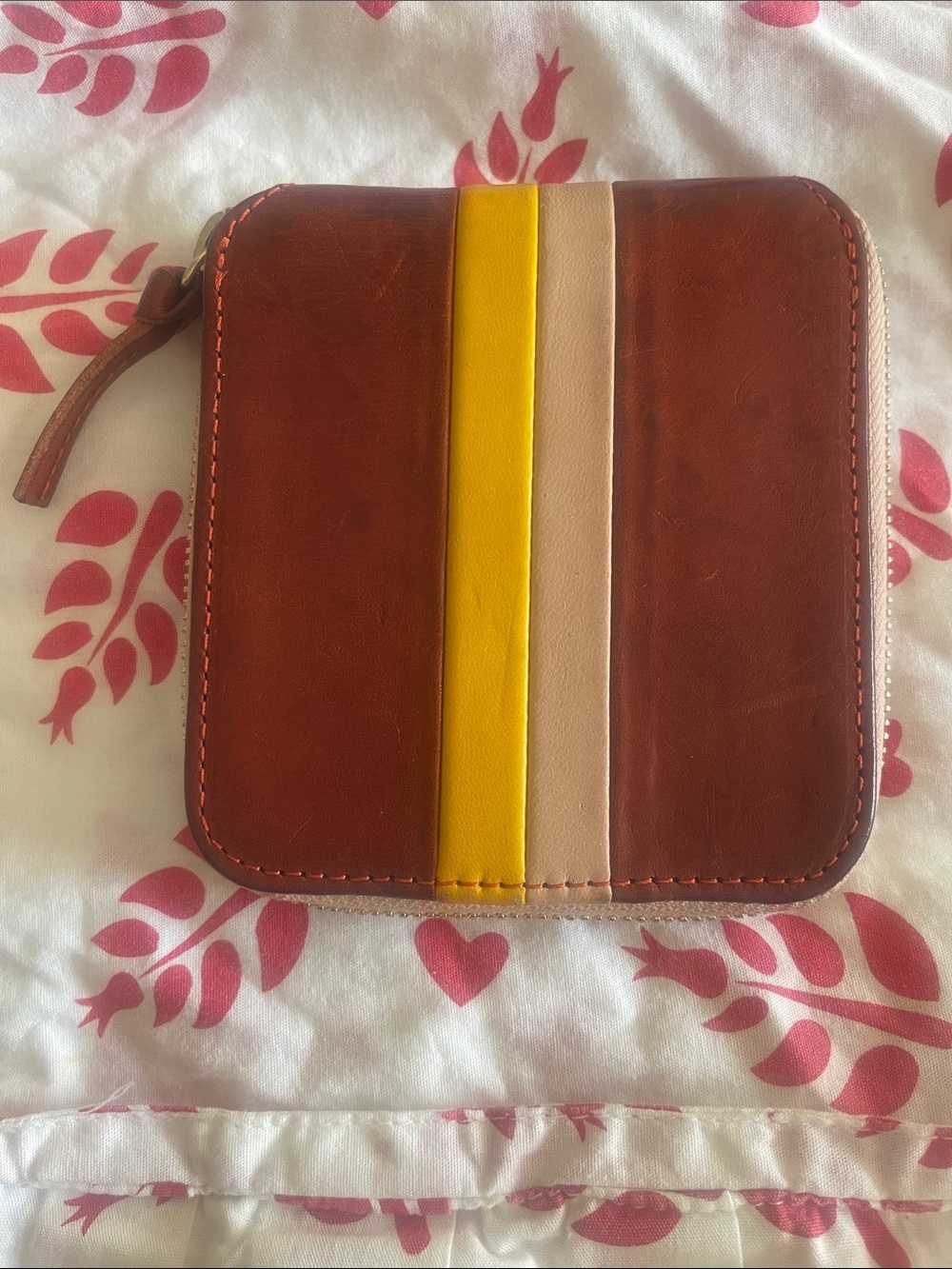 Clare V. Petit Zip Wallet in Cuoio leather with a yellow stripe.